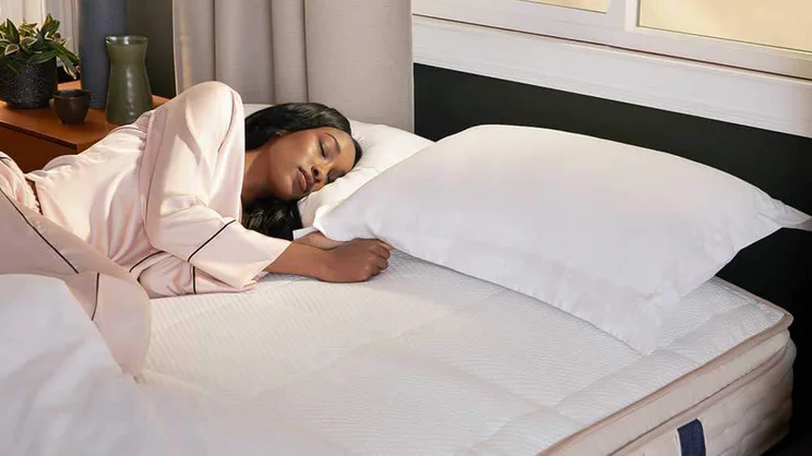 DreamCloud luxury hybrid mattress on a bed