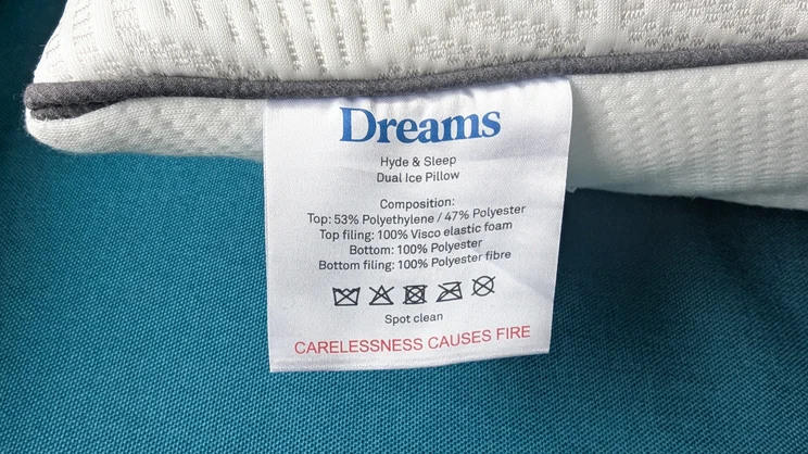 A closeup of the Dreams Hyde and Sleep Dual Comfort Ice pillow's care label