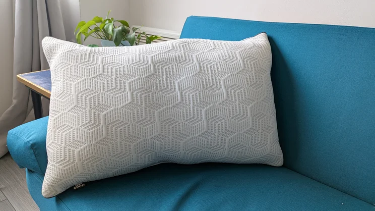 The Dreams Hyde and Sleep Dual Comfort Ice pillow on a blue sofa in a living room