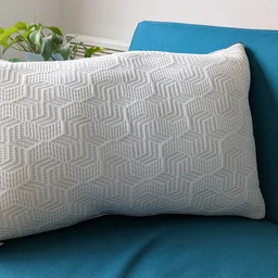 The Dreams Hyde and Sleep Dual Comfort Ice pillow on a blue sofa in a living room