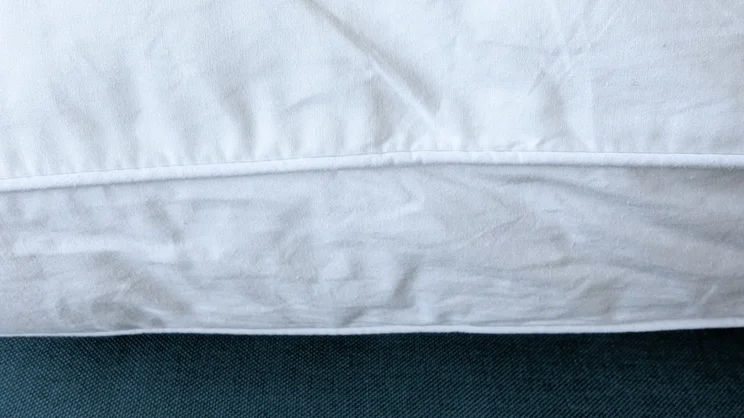 A closeup view of the Dreams Side Sleeper Pillow's piped stitching