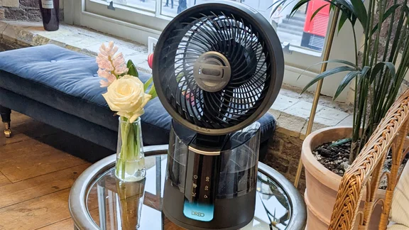 The Dreo TurboCool 516S fan on a glass table, in a showroom
