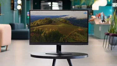 The AOC 27G4XE pictured head on on a circular black table