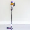 dyson v15 detect absolute in purple on a cream wallpaper background