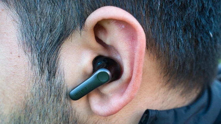 The left earbud of the EarFun Air Pro 4+ being worn by our reviewer, Simon Cocks