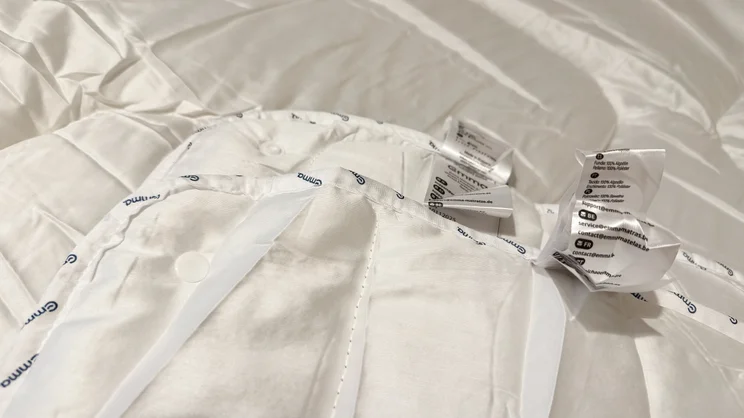 A closeup of the Emma All Seasons Customisable Duvet's corners with care labels