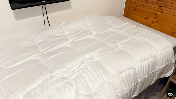 The Emma All Seasons Customisable Duvet on a single bed in a bedroom