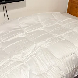 The Emma All Seasons Customisable Duvet on a single bed in a bedroom