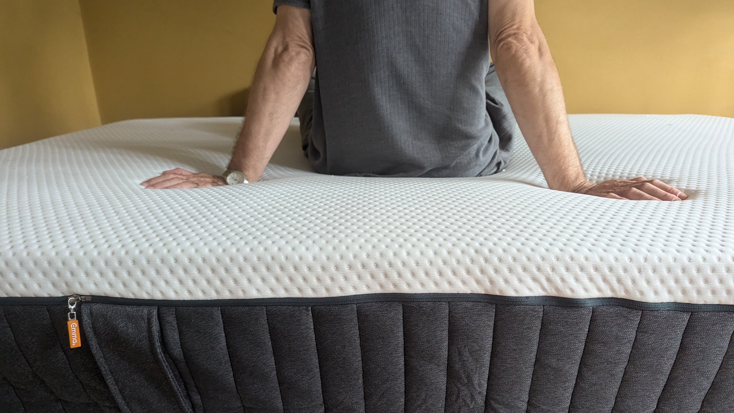 Emma NextGen Cooling mattress with man sat on top