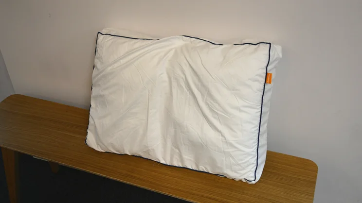 Emma Original Hybrid Pillow review_lead white piloow with black piped edge on a wooden surface