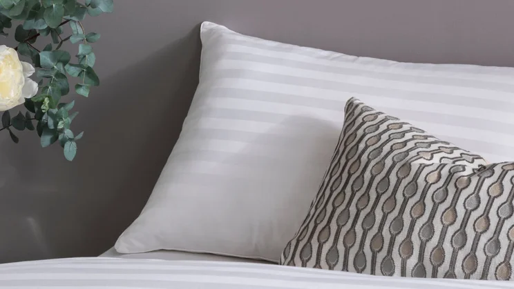 Fine Bedding Co Boutique Silk Pillow review pillows on a bed with a scatter cushion in front of it