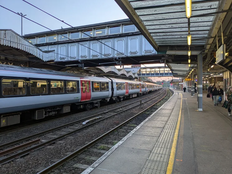 Train station in the evening with a train waiting at the platform