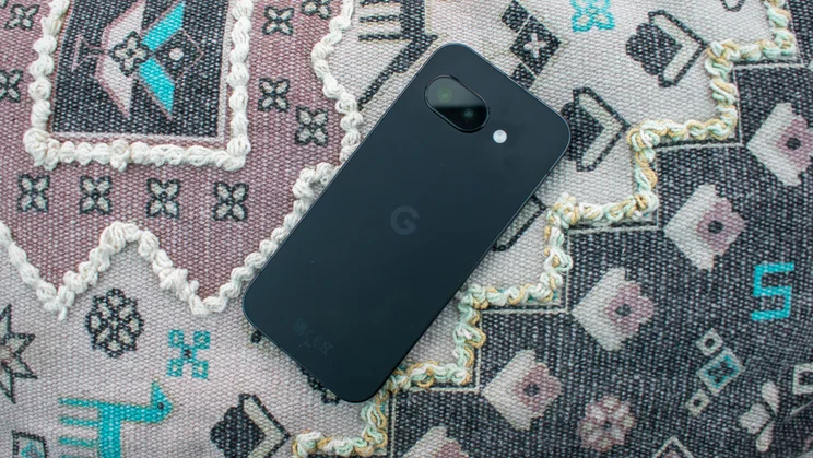 Google Pixel 9a on a patterned cushion, face down