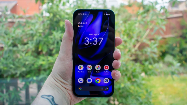 Google Pixel 9a in hand, front view