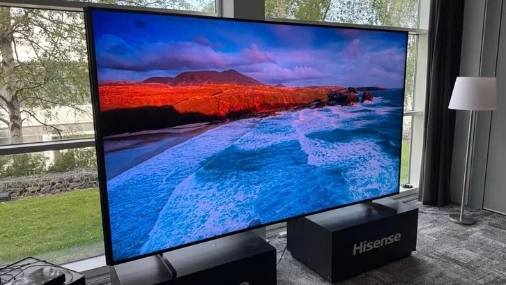 The 116in Hisense UXQ RGB Mini LED TV displaying a coastal scene