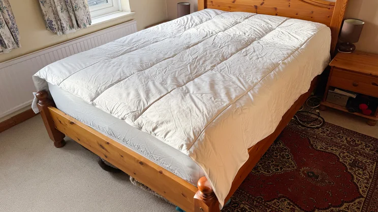 the Homescapes Indulgent Pure Mulberry Silk Blend duvet laid over a bed in a bedroom