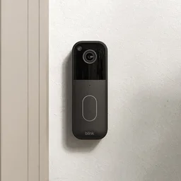 The Blink Video Doorbell (2ns generation) pictured mounted on a wall next to a front door