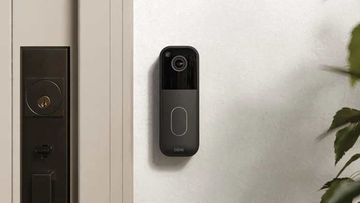 The Blink Video Doorbell (2ns generation) pictured mounted on a wall next to a front door