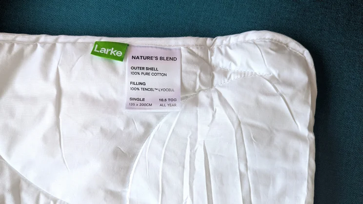 A closeup of the Larke Nature's Blend duvet, with the brand and care labels along the top edge