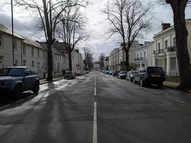 A long street lined with cars