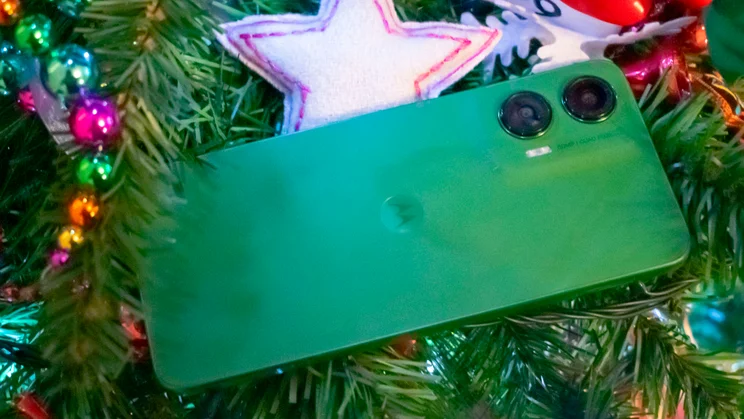 Motorola Moto G35 5G, rear view, nestled in the branches of a Christmas tree