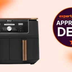 The Ninja Foodi Max Dual Zone air fryer on an orange and white background. A badge to the right reads "Expert Reviews Approved Deal"