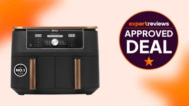 The Ninja Foodi Max Dual Zone air fryer on an orange and white background. A badge to the right reads "Expert Reviews Approved Deal"