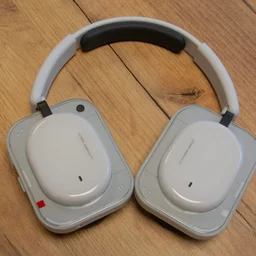 The Nothing Headphone (a) over-ear headphones on a wooden table