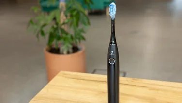 The Oclean X Pro 20 toothbrush on a table in an office
