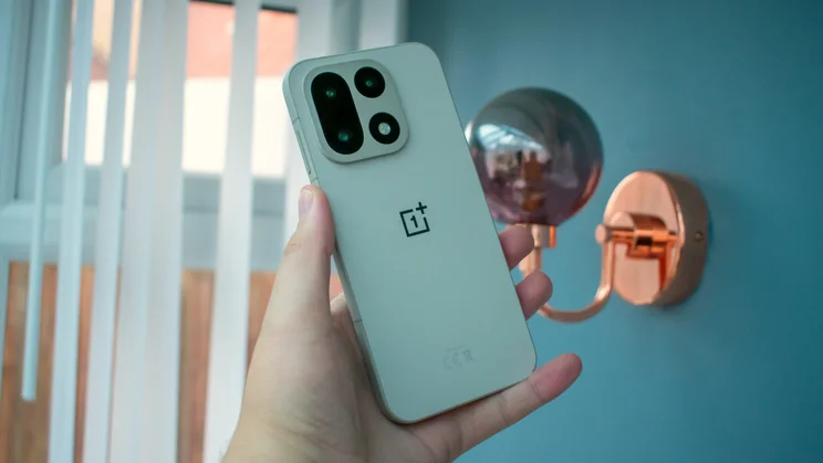 OnePlus 15 in hand, rear view