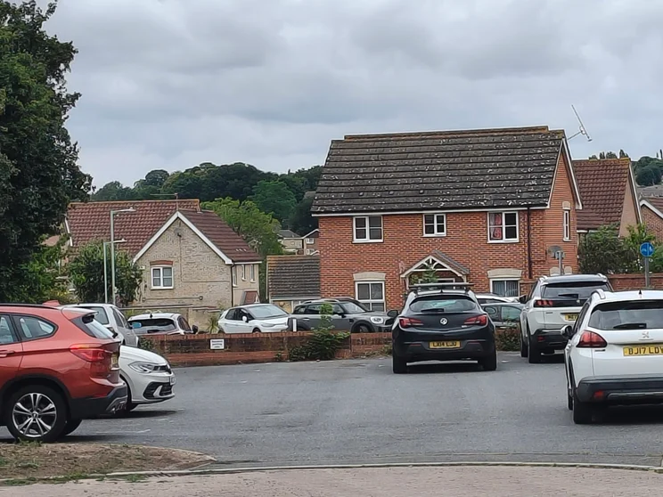 5x zoom of houses with cars parked out front