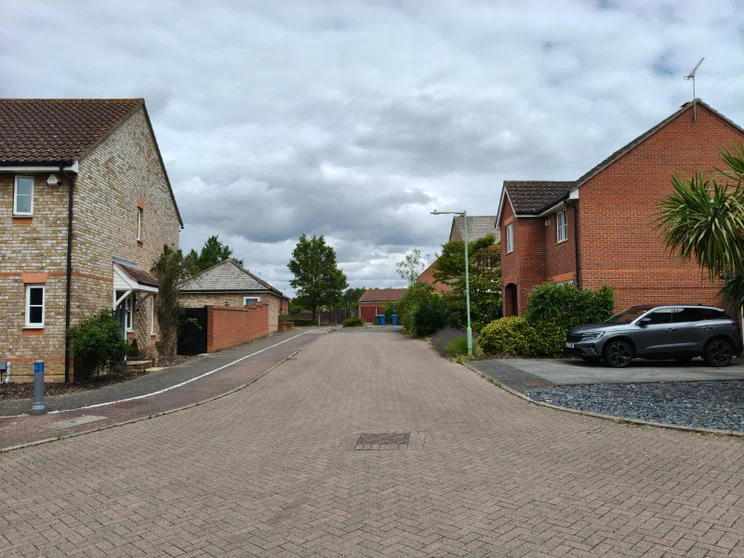 An empty road with houses on both sides
