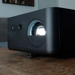 The Optoma Photon Life PK32 projector on a wooden table