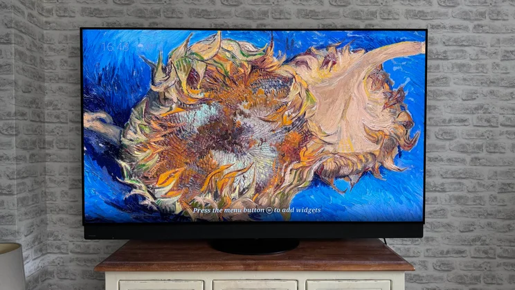 Front view of the Panasonic Z95B OLED displaying a Fire TV Ambient Experience screensaver