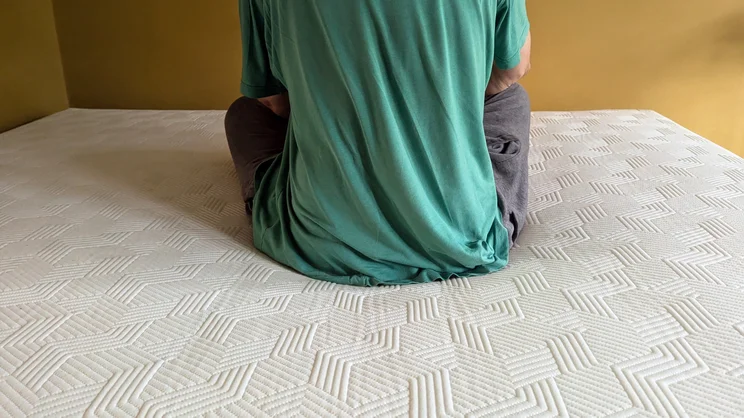 A person sitting on the Panda Hybrid Bamboo mattress