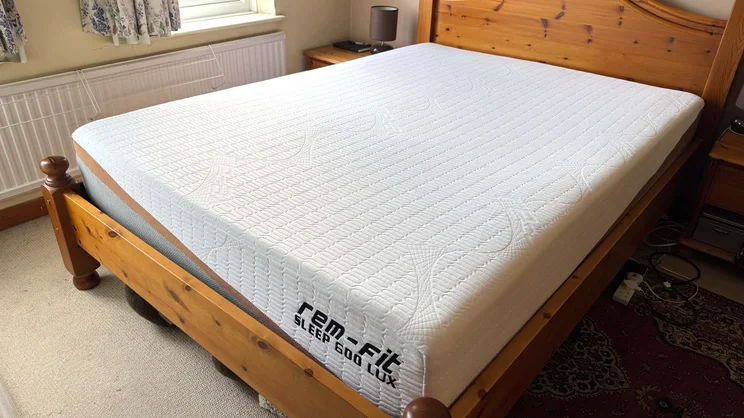 The REM-Fit 600 Lux Elite mattress on a wooden bed frame
