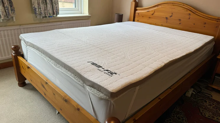 The REM-Fit Halo mattress topper strapped to a mattress