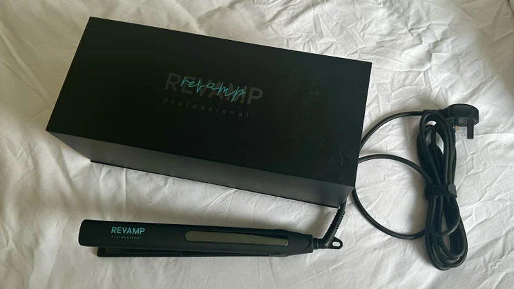 best hair straighteners on the bed with the original box and straightener next to it