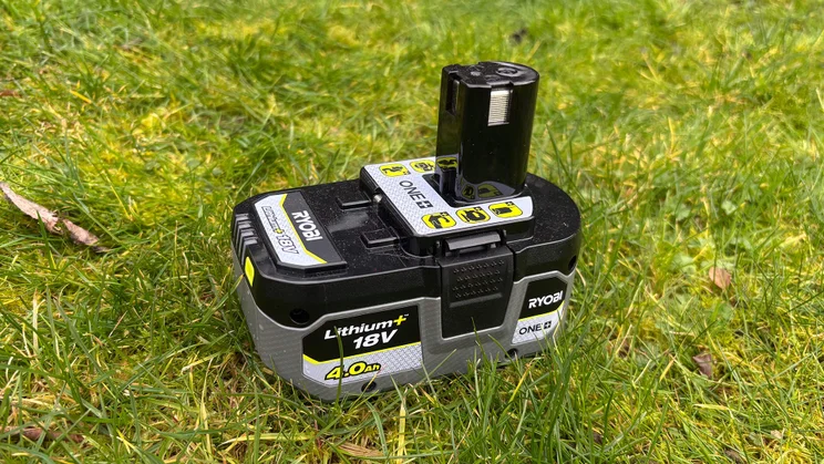 Ryobi RY18LT23A-0 grass trimmer - battery pack on grass