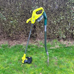 Ryobi RY18LT23A-0 grass trimmer - wide shot of trimmer propped up on grass