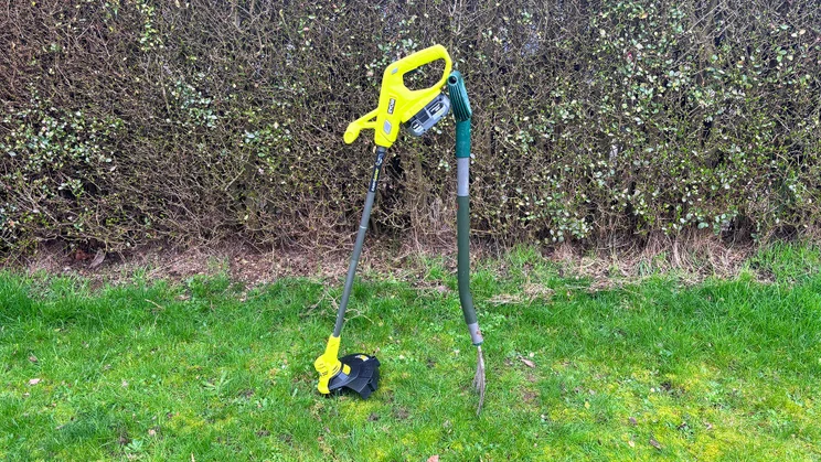 Ryobi RY18LT23A-0 grass trimmer - wide shot of trimmer propped up on grass