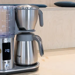 The Sage Luxe Brewer filter coffee machine on a wooden bench