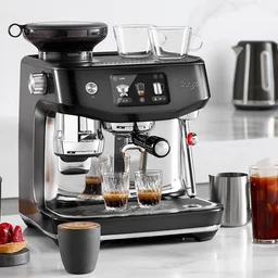 Sage Oracle Jet coffee machine sat on counter with coffees and pastries