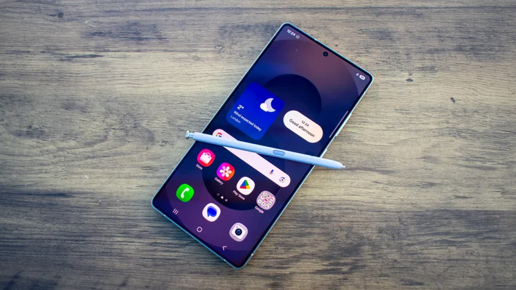 Samsung Galaxy S25 Ultra lying face up on a table with the display on and the S Pen Stylus sitting on the screen