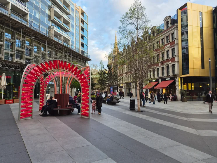 A square fill with people surrounded by tall buildings