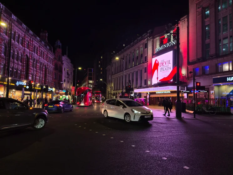 An intersection at night with the Devil Wears Prada theatre