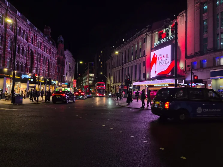 An intersection at night with the Devil Wears Prada theatre