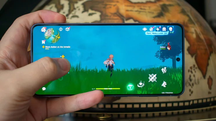 Samsung Galaxy S26 in hand, displaying a mobile game