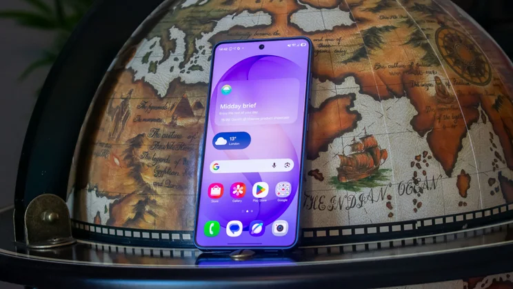 Samsung Galaxy S26 leaning on a globe, front view
