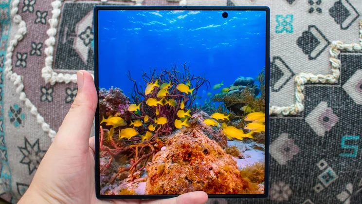 Samsung Galaxy Z Fold 7 unfolded in hand, showing an underwater scene on the display